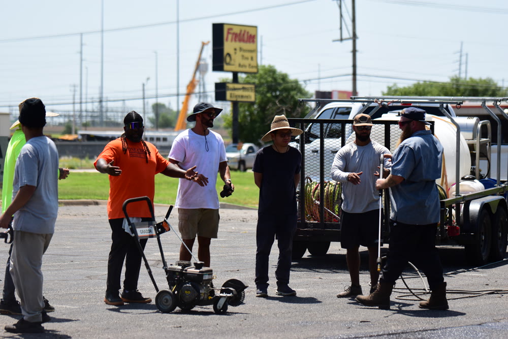 Chris briefing a training crew before a striping job